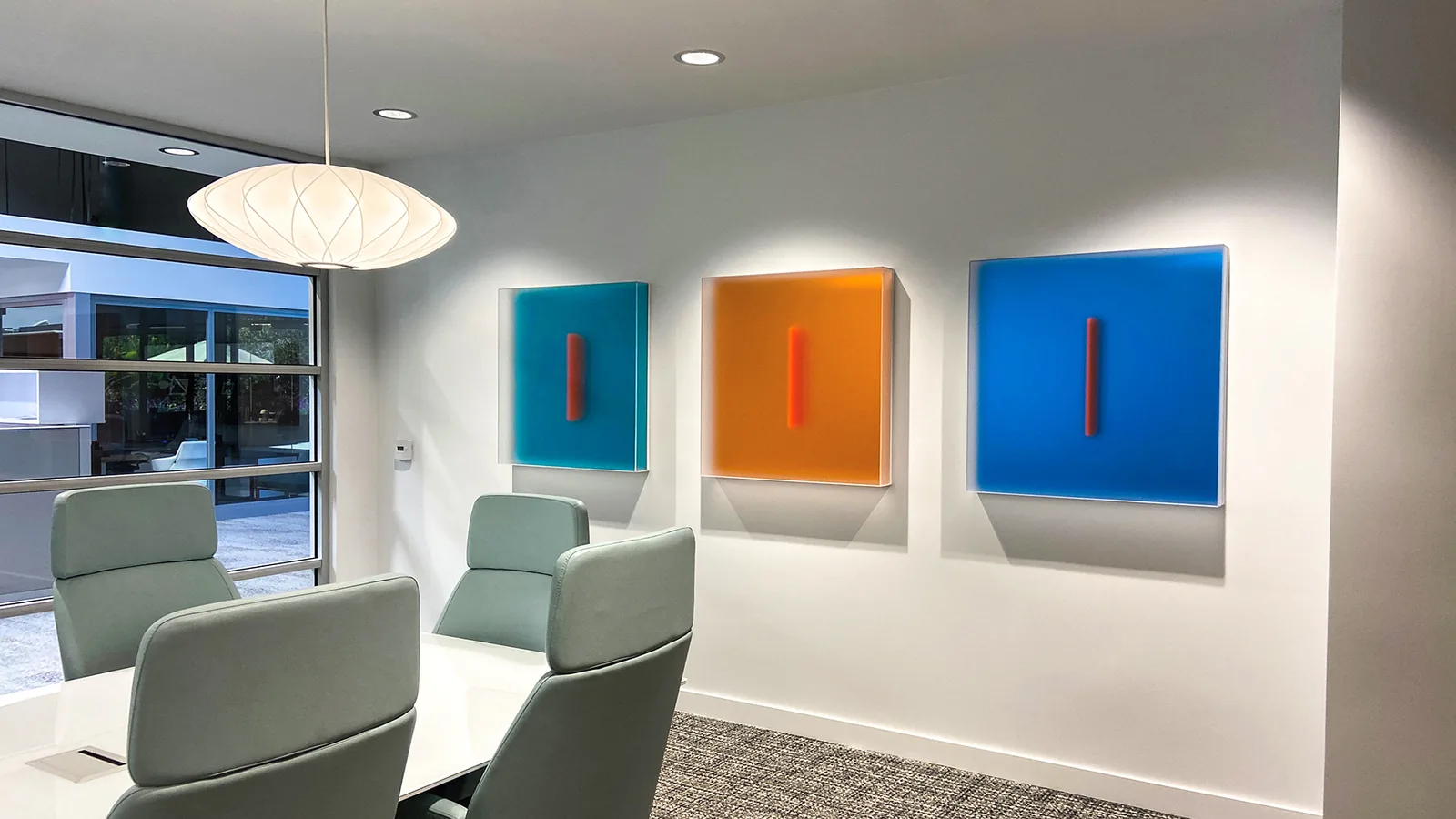 Three Casper Brindle Light Glyphs installed in a conference room.