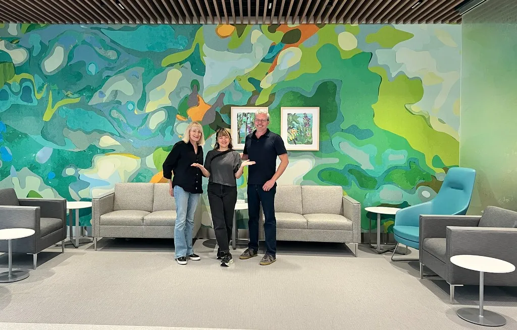 The project team in front of the large commissioned mural at UC San Diego Health.