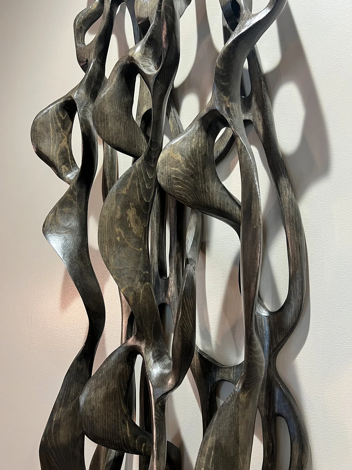 A vertical artwork in a Mintz corridor.